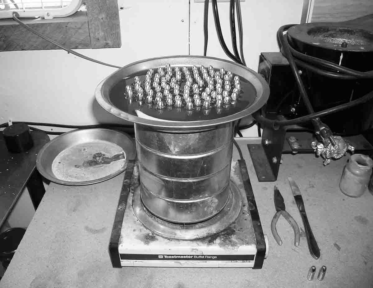 Double boiler for pan lubing utilizing a coffee can for a water tin and pie tin for a bullet tray.